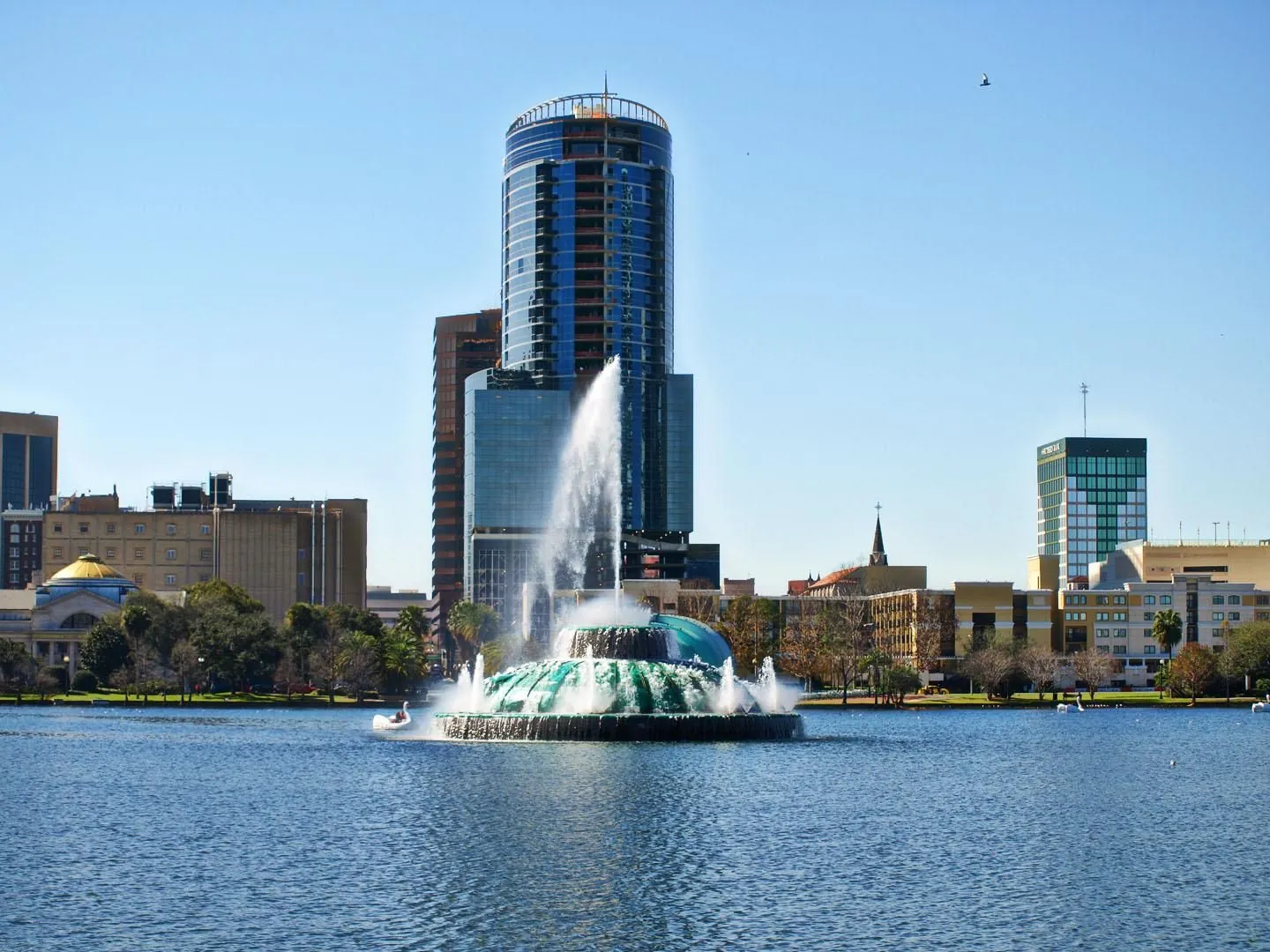 Lake Eola fountain and downtown Orlando buildings.