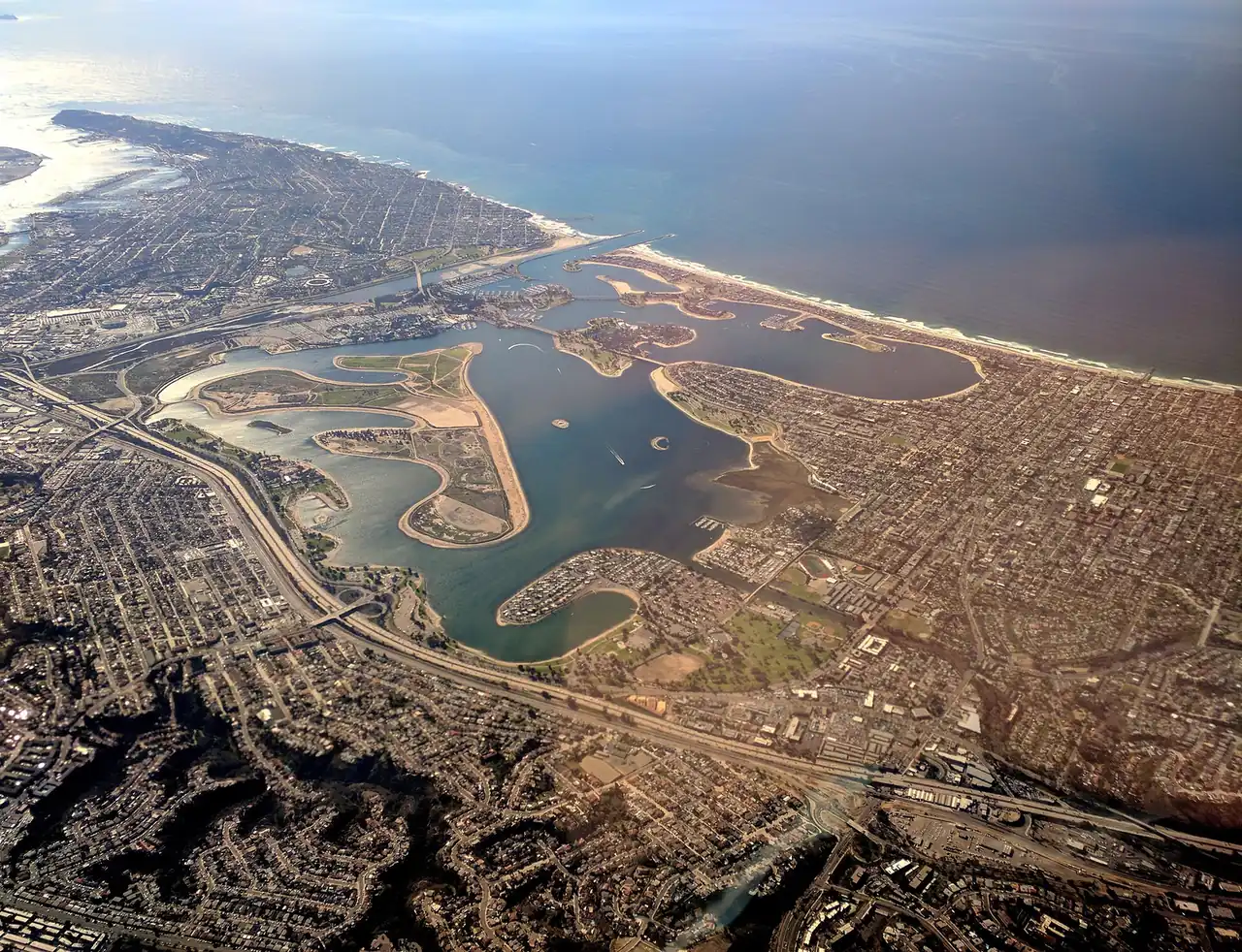 Mission Bay in San Diego viewed from above with bay water, islands, roads, and nearby neighborhoods.